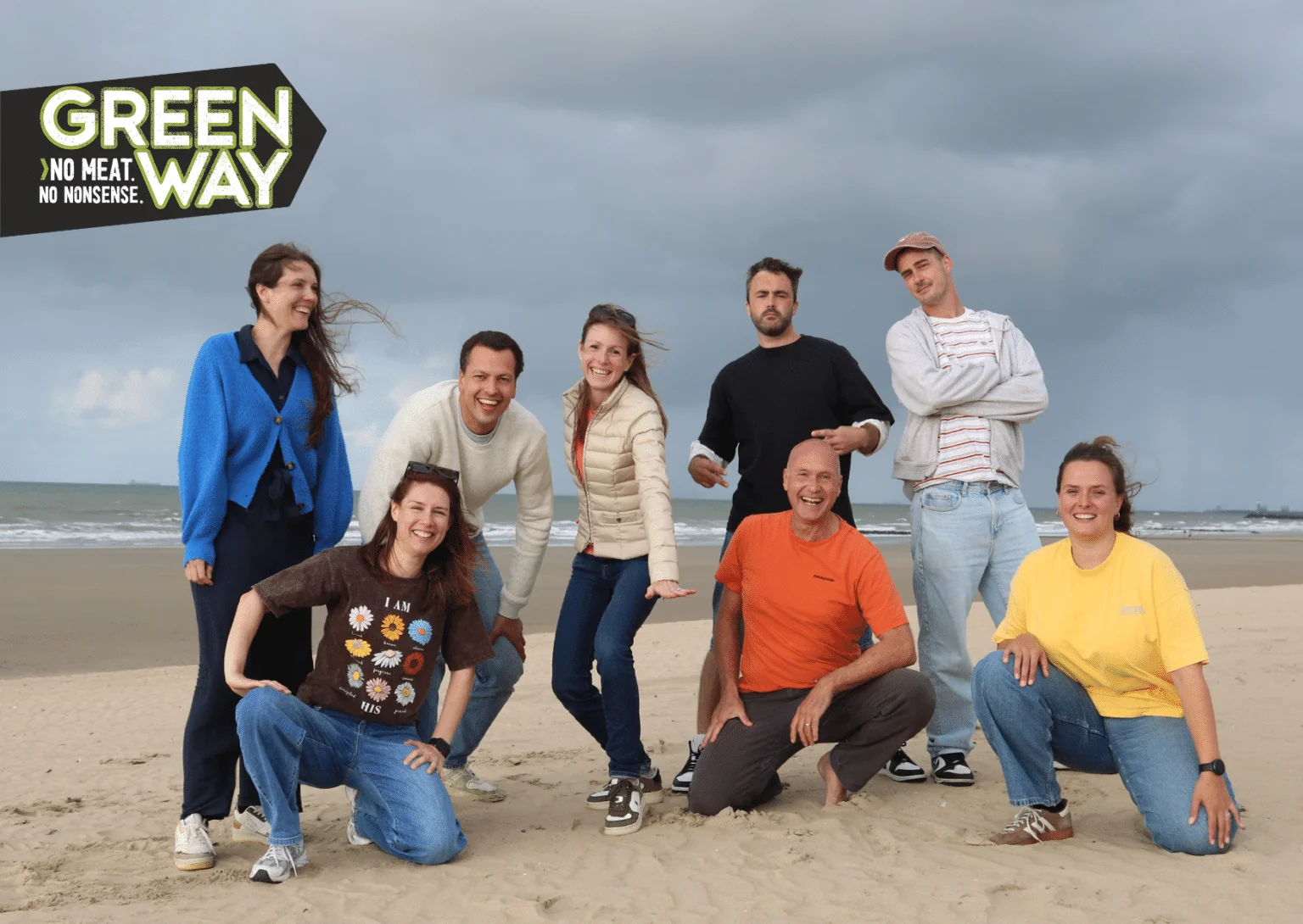The Greenway team on the beach, with the Greenway logo.